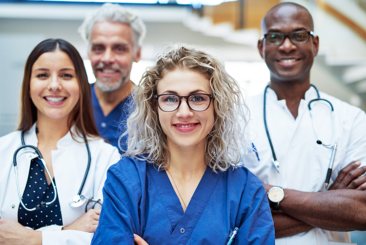 group of healthcare workers standing together proudly