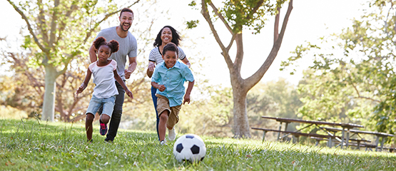 Family playing soccer